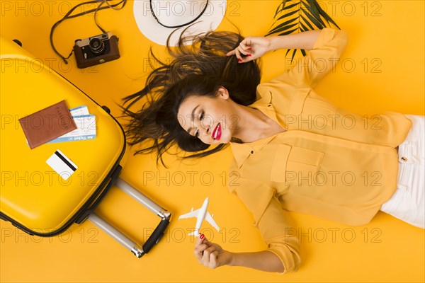 Flat lay woman posing travel essentials