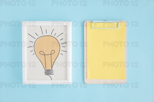 Hand drawn light bulb frame clipboard with yellow paper