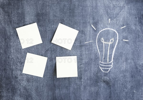 Blank adhesive notes light bulb drawn chalkboard