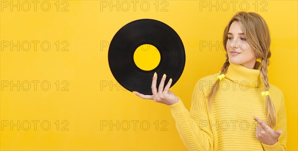Medium shot woman holding vinyl