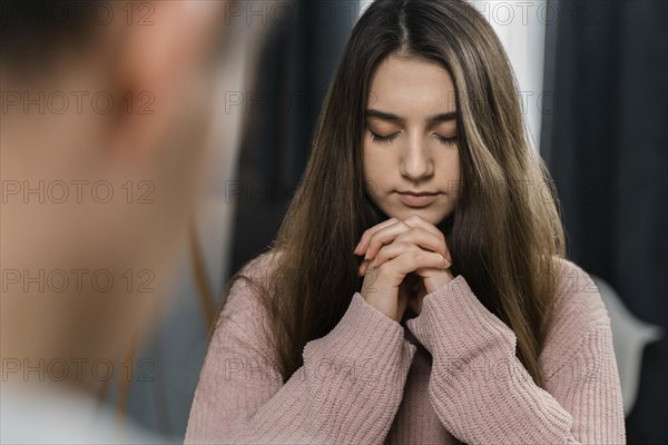 People praying home before dinner