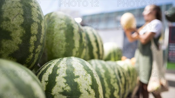 Woman looking fresh watermelon with copy space