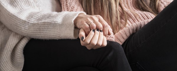 Close up daughter mom holding hands