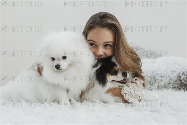 Girl cute white pups sitting bed