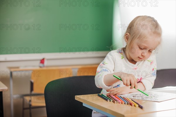 Cute girl sitting drawing