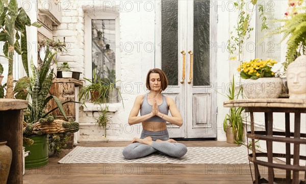 Woman meditates indoors