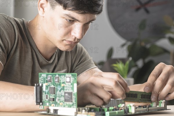 It technician students inserting ram computer motherboard