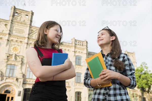 Low angle teenage girls talking