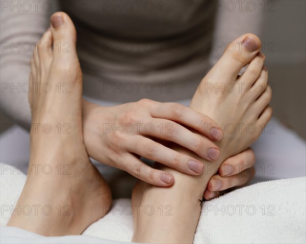 Close up therapist massaging foot