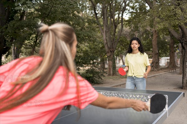 Medium shot girls playing table tennis