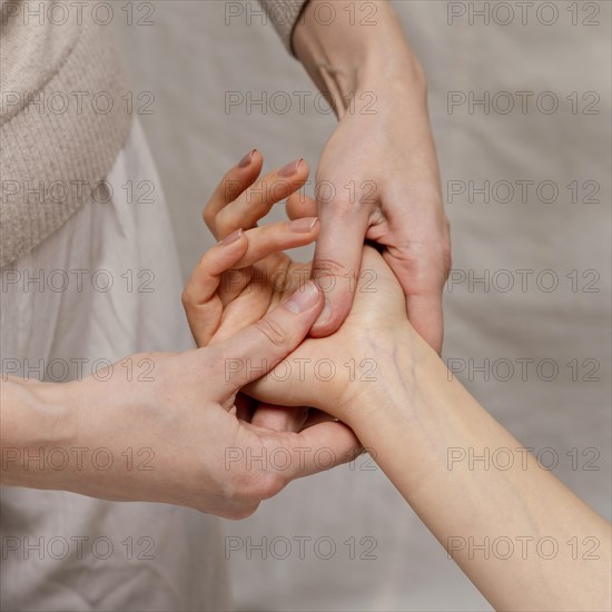 Close up therapist massaging palm