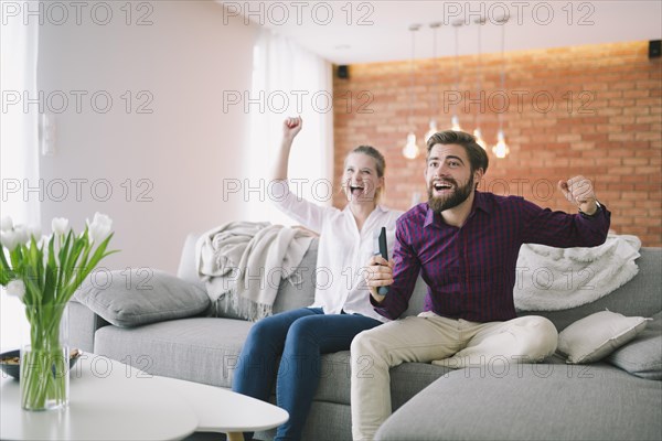 Couple enjoying tv couch