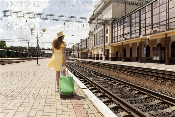 Full shot woman train station