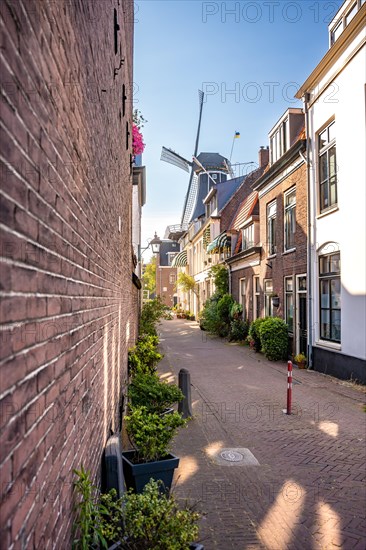 Narrow alleyway with historic mill at the end