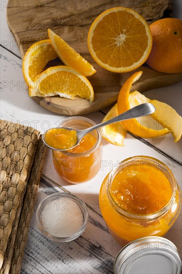 High angle transparent glass jar with orange jam