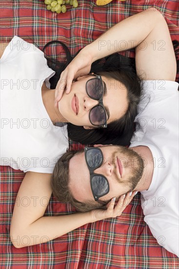 Top view couple laying picnic blanket