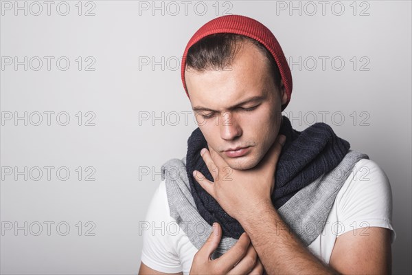 Man with closed eyes suffering from cough