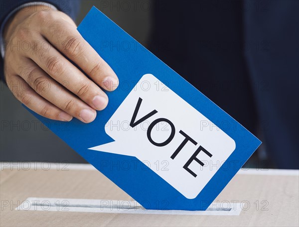 Person putting ballot election box