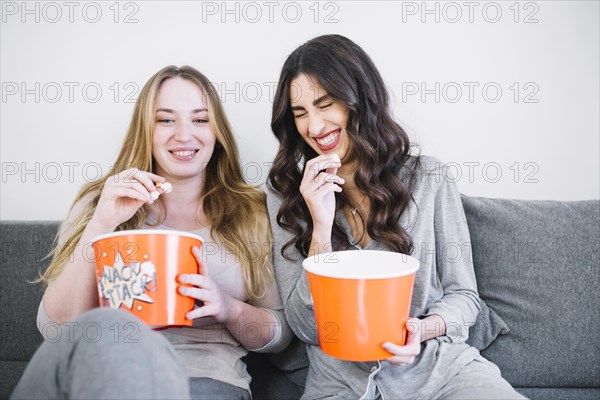 Laughing women with popcorn