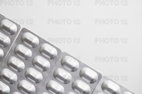 Overhead view silver pills blister pack white background