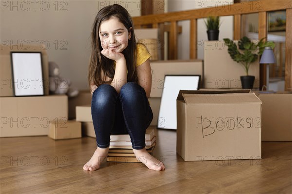 Full shot girl sitting books