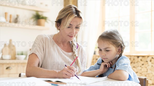 Mother daughter doing homework home