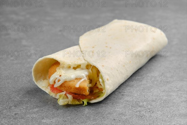 Flatbread stuffed with fish patty in breading with melted cheese and iceberg lettuce