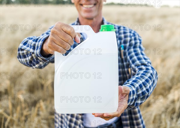 Man holding canister with anti pests