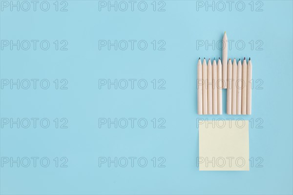 Blank sticky note with rows colored pencil blue background