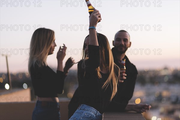 Friends drinking beer roof