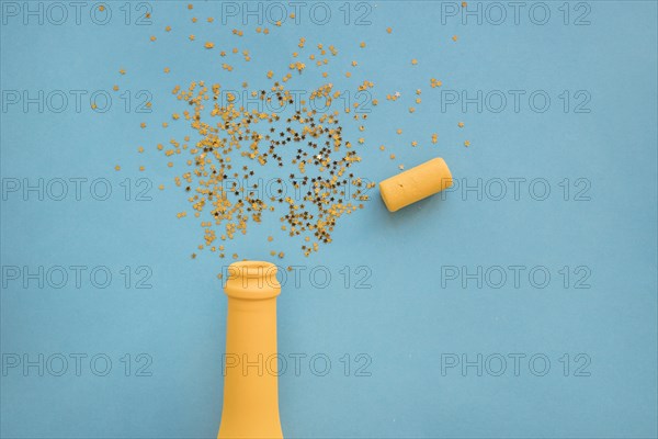 Spangles scattered from bottle table