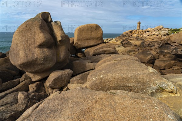 The rocks of the pink granite coast Cote de Granit Rose and the lighthouse Phare de Ploumanac'h near Ploumanac'h