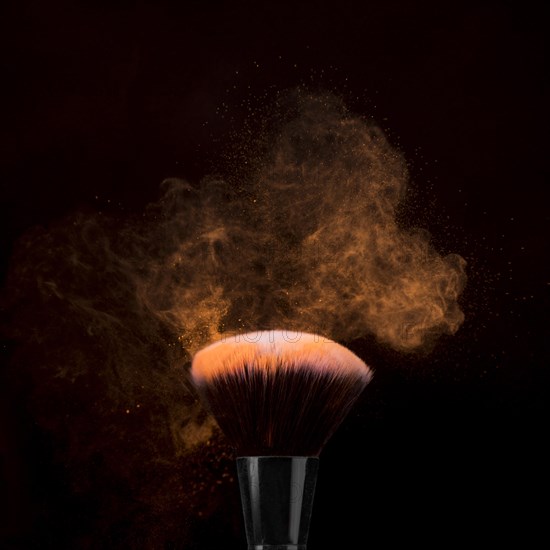 Brush makeup powder burst dark background