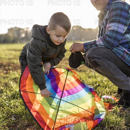 Father son fixing kite