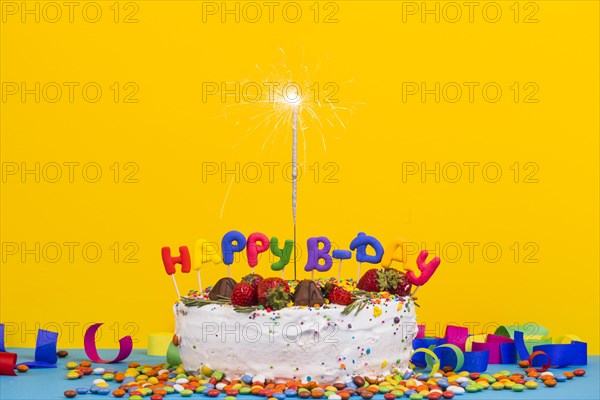 Front view birthday cake with sparkler