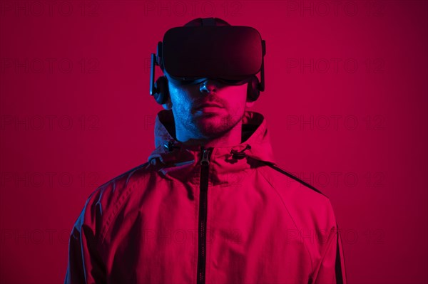 Man wearing virtual reality gadget with red light