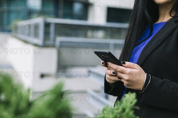 Businesswoman s hand using cellphone