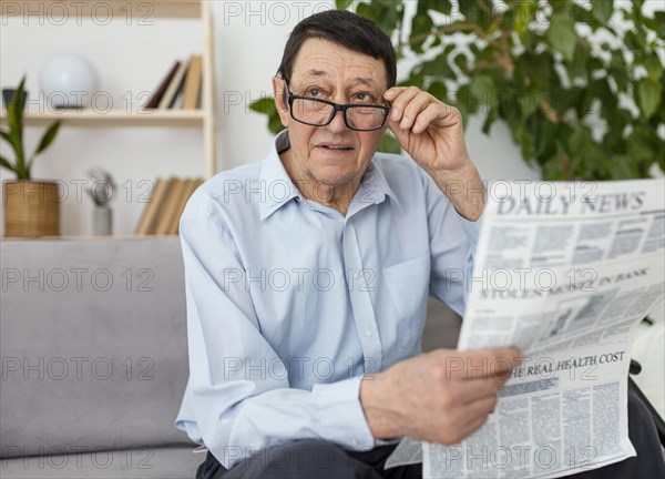 Medium shot man holding newspaper