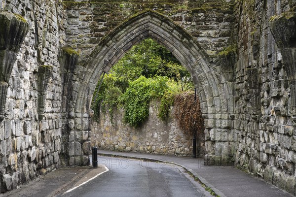 Road leading through the ruins of the 14th century gatehouse called The Pend