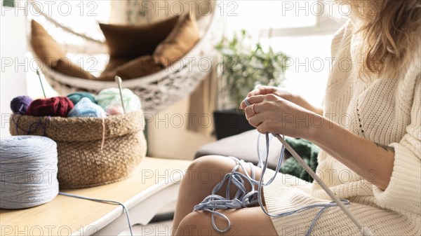 Woman crocheting indoors