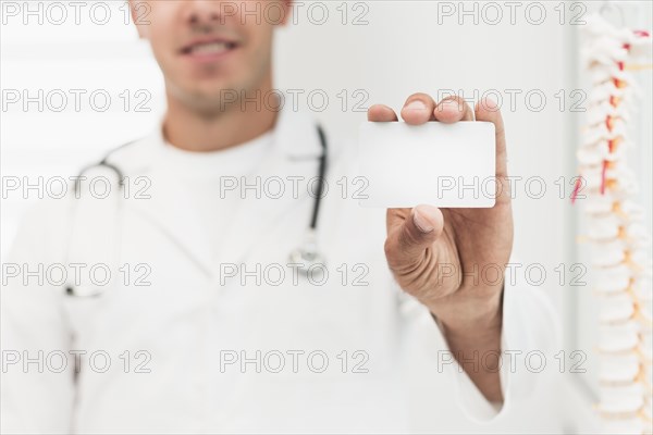 Smiling doctor showing card mock up