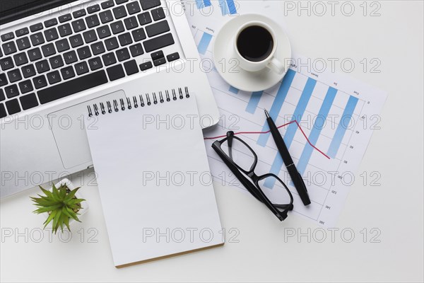 Top view desk with notebook coffee