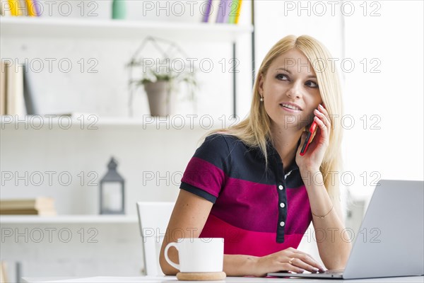 Beautiful young woman talking mobile phone