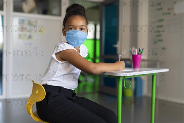 Little girl using medical mask class