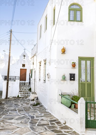 White Cycladic houses with green windows and doors