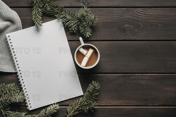 Top view hot chocolate with blank notebook copy space