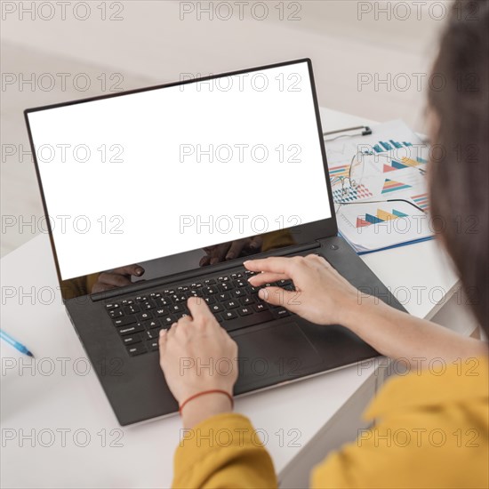 High angle pregnant businesswoman working laptop