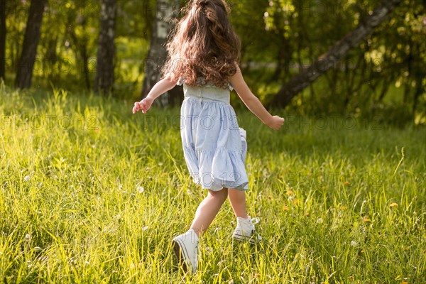 Rear view girl running park