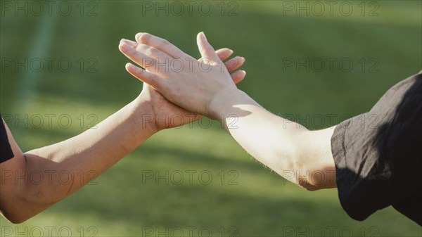 Beautiful female hands high five