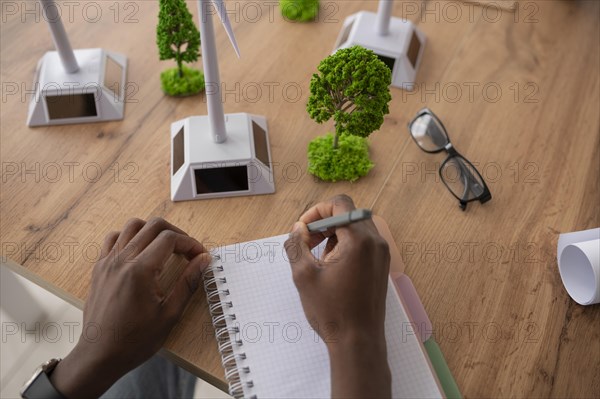 Close up man writing notebook